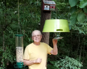 Photo by Senia Owensby Wayne pauses to smile as he checks one of our bird feeders. Bird watching has become an important part of our quality of life.