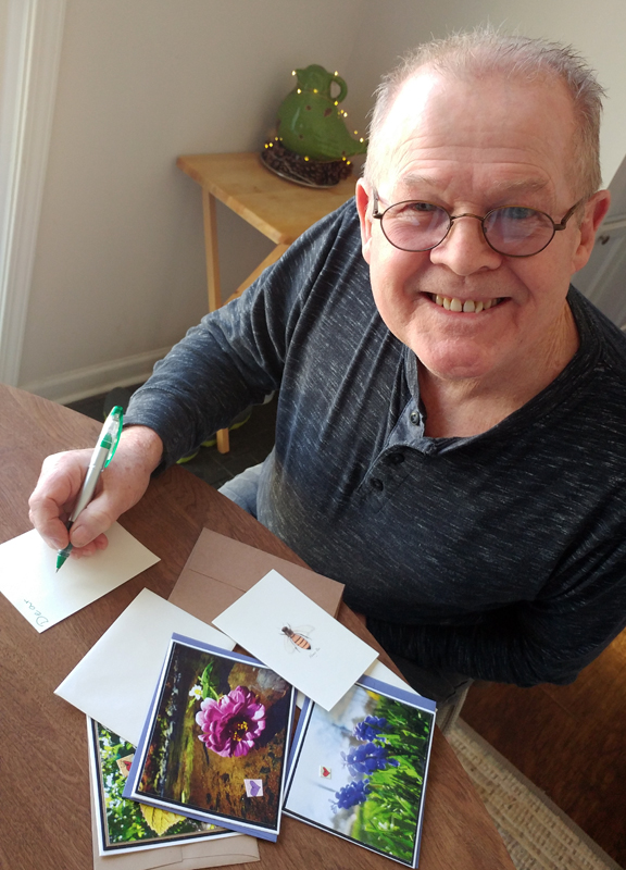 Wayne pauses while writing a note to give me a smile.
