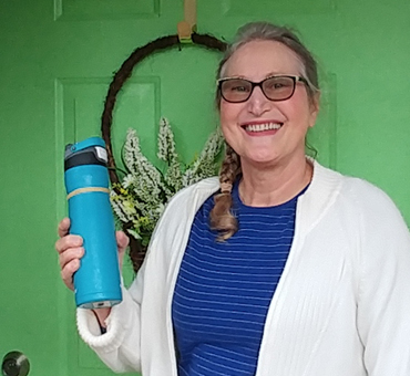 I am getting ready to leave my house armed with my trusty water bottle. You can see I have added a rubber band around it to make it easier to take the top off.