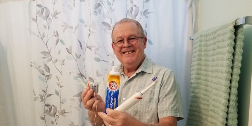 Wayne is holding some of the items he uses to fight dental issues every day.